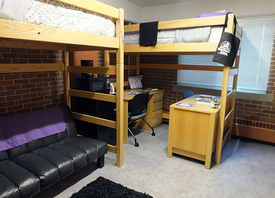 Beds lofted with desks and futon situated underneath